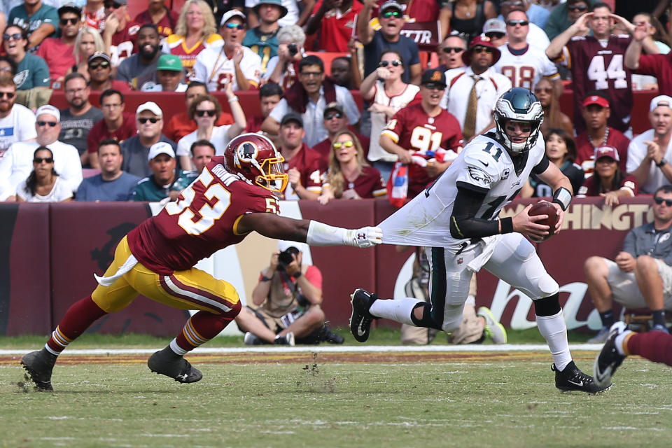 <p>Philadelphia Eagles quarterback Carson Wentz (11) scrambles with the ball as Washington Redskins linebacker Zach Brown (53) chases in the fourth quarter at FedEx Field. The Eagles won 30-17. Mandatory Credit: Geoff Burke-USA TODAY Sports </p>