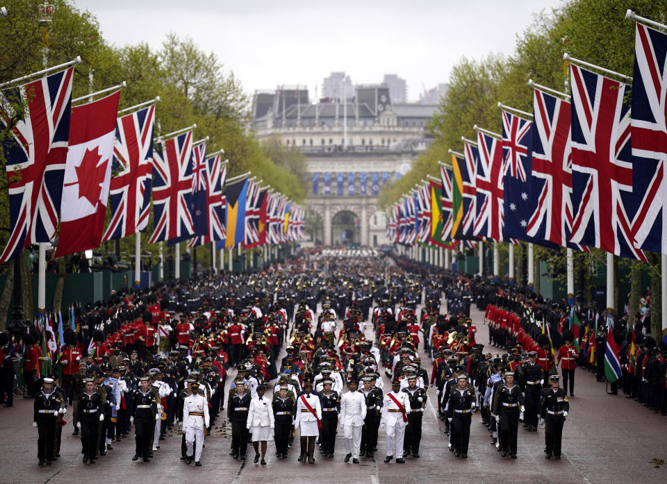 <p>The Coronation Procession passes along The Mall to Buckingham Palace following the coronation ceremony of King Charles III and Queen Camilla in central London. Thousands of members of the armed forces from across the Commonwealth and British Overseas Territories, members of the UK armed forces and the Sovereign's Bodyguard and Royal Watermen, are taking part in the celebrations through central London in the largest military operation in 70 years. Picture date: Saturday May 6, 2023. (Photo by Niall Carson/PA Images via Getty Images)</p> 