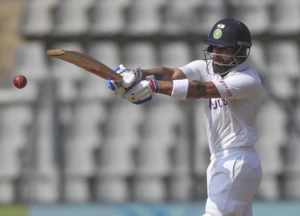 India's captain Virat Kohli plays shot during the day three of their second test cricket match with New Zealand in Mumbai, India, Sunday, Dec. 5, 2021.(AP Photo/Rafiq Maqbool)