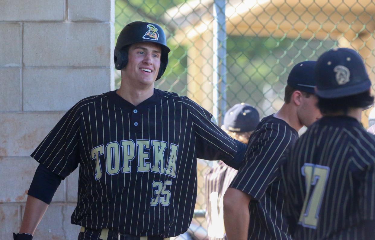 Topeka High's Hank Stamper celebrates in the dugout against St. Mary's Academy on Thursday, May 9.