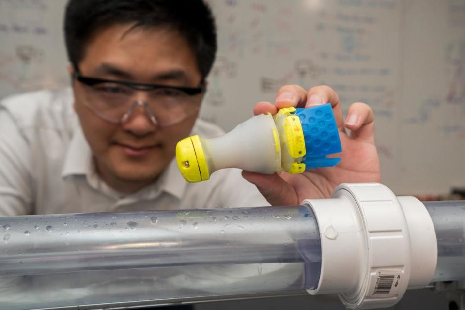 You Wu with his robot pipe cleaner that can track down water leaks in pipes (James Dyson Award)