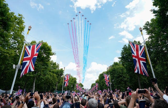 The Red Arrows perform a flypast along the Mall 