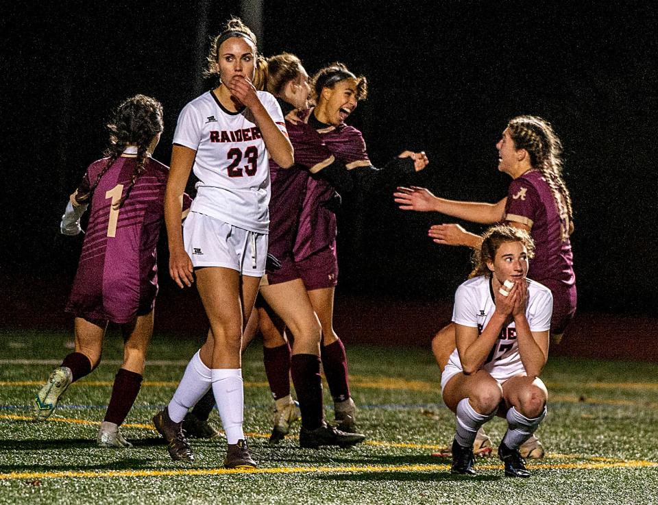 Algonquin Regional High School senior Gabby Miranda, center, after scoring the game winning goal in sudden death overtime against Wellesley, at Walpole High School, Nov. 16, 2022. The Titans advance to the Div. 1 state girls soccer finals. 