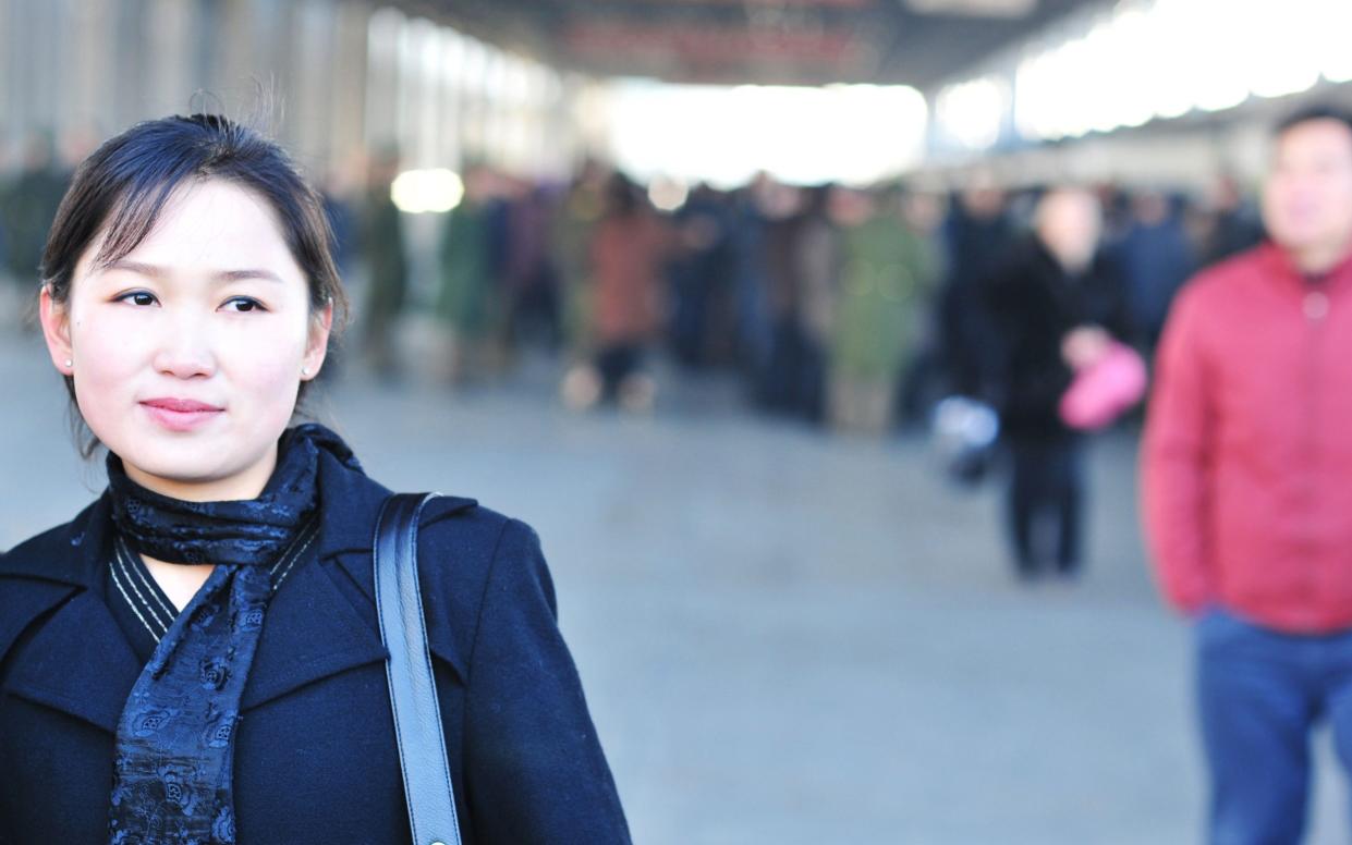 Woman waiting for the train in Pyongyang, North Korea