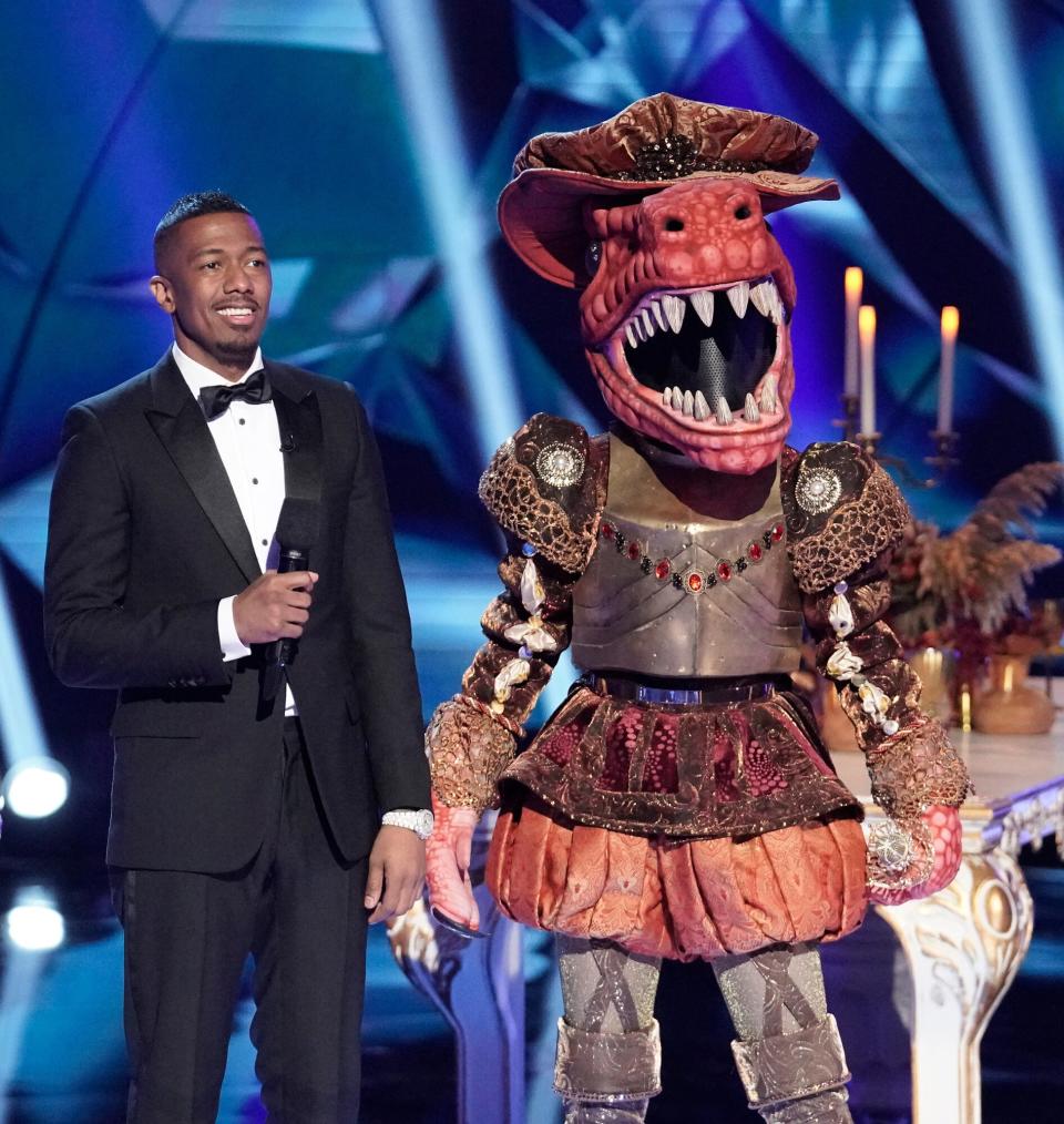 Host Nick Cannon and T-Rex in the It Never Hurts to Mask: Group C Playoffs episode of THE MASKED SINGER