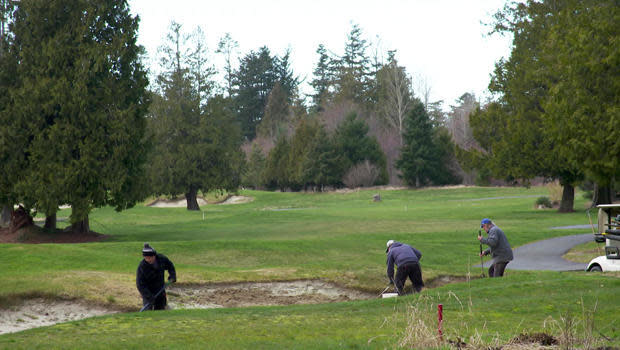 Groundskeepers tend the links at the Bald Eagle Golf Club.  / Credit: CBS News