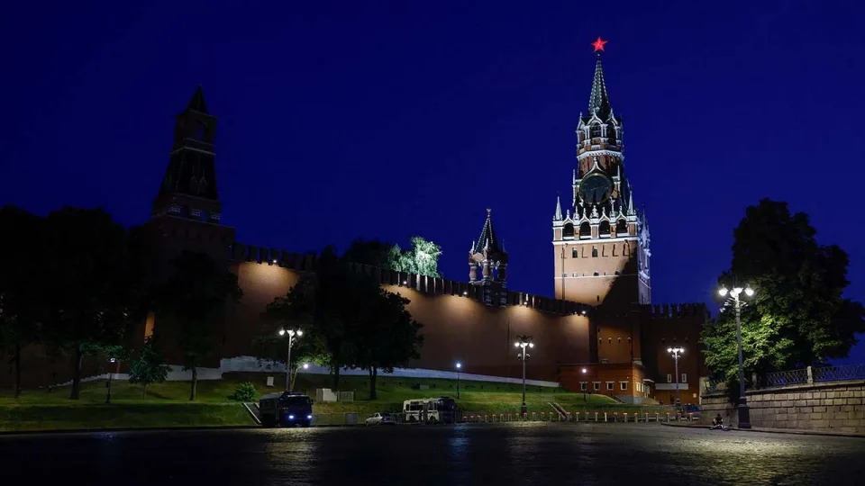 Law enforcement vehicles are seen in front of the Kremlin's Spasskaya Tower