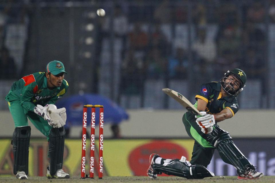 Pakistan’s Fawad Alam, right, plays a shot, as Bangladesh’s Anamul Haque watches during their match in the Asia Cup one-day international cricket tournament in Dhaka, Bangladesh, Tuesday, March 4, 2014. (AP Photo/A.M. Ahad)