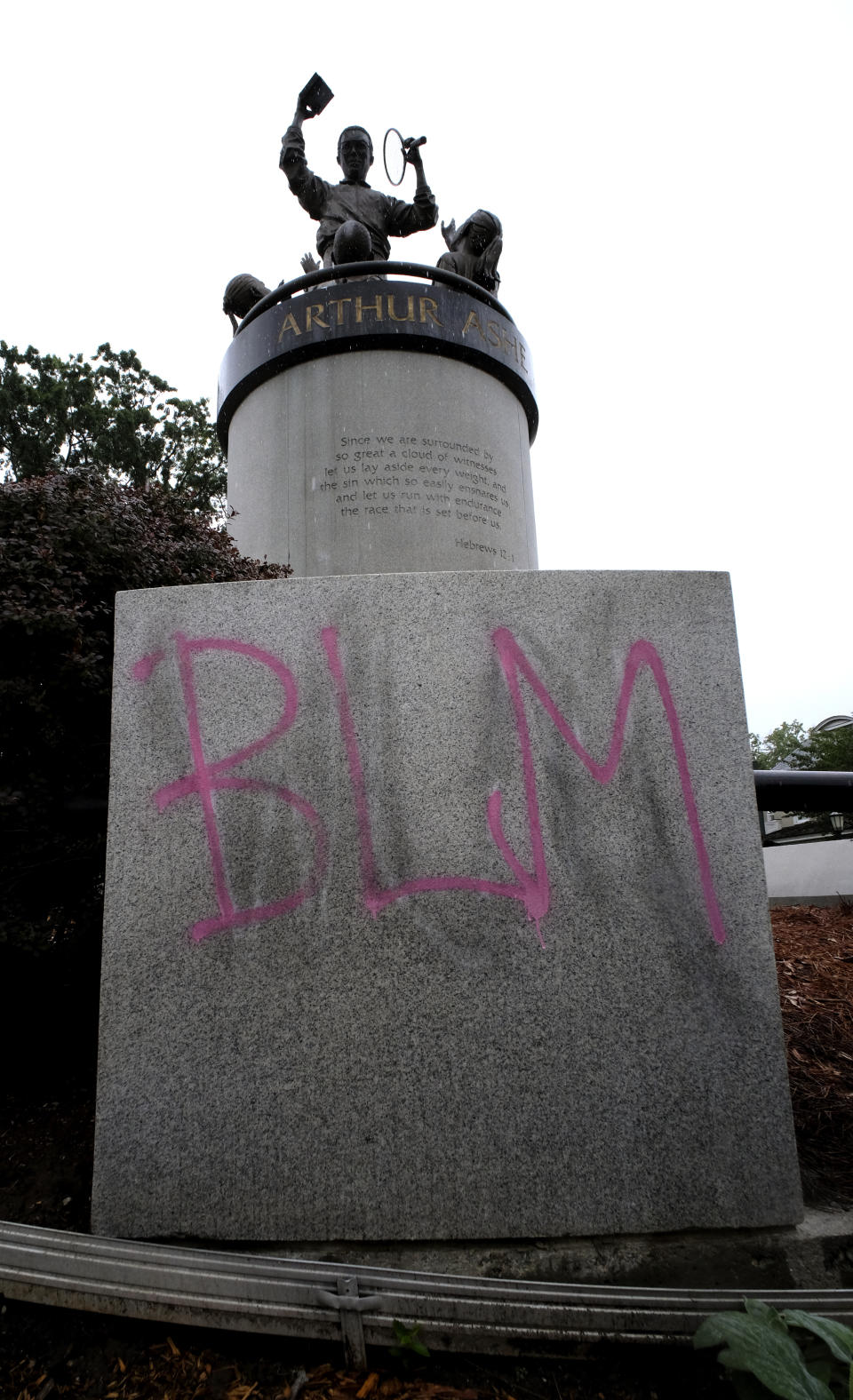 Paint covers the base of the Arthur Ashe Monument on Wednesday, June 17, 2020 in Richmond, Va. The statue of the African American tennis legend has been vandalized with the words “White Lives Matter.” Richmond Police said they were alerted to the vandalism early Wednesday. Police say red paint on the statue itself was already being cleaned off by community members. (Bob Brown/Richmond Times-Dispatch via AP)