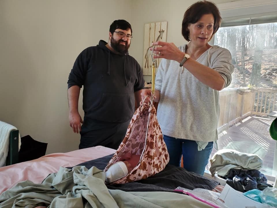 Kyle Skolsky with a midwife weighing his newborn daughter Galaxy Veronica Mave, who was born on New Year's Day morning at their Rockaway Township home with her husband,