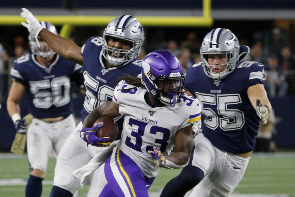 Minnesota Vikings running back Dalvin Cook (33) runs the ball as Dallas Cowboys' Robert Quinn (58) and Leighton Vander Esch (55) give chase during the first half of an NFL football game in Arlington, Texas, Sunday, Nov. 10, 2019. (AP Photo/Michael Ainsworth)