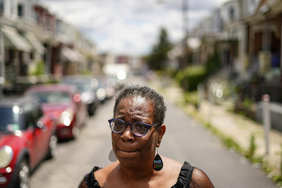 In this July 9, 2021 photo, Michelle Bolling poses for a photograph outside of her home in Philadelphia. Bolling's son is one of the increasing numbers of nonfatal gun violence victims. Homicide rates in many American cities have continued to rise although not as precipitously as the double-digit jumps seen in 2020 and still below the violence of the mid-90s. (AP Photo/Matt Rourke)