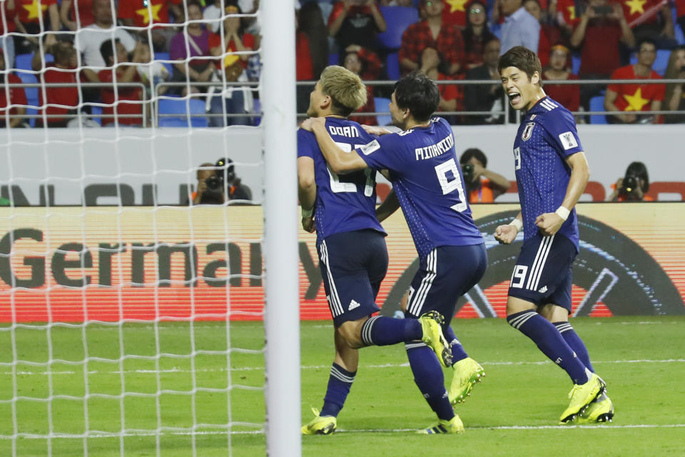 Japan players celebrate the opening goal during the AFC Asian Cup quarterfinal soccer match between Japan and Vietnam at Al Maktoum Stadium in Dubai, United Arab Emirates, Thursday, Jan. 24, 2019. (AP Photo/Hassan Ammar)