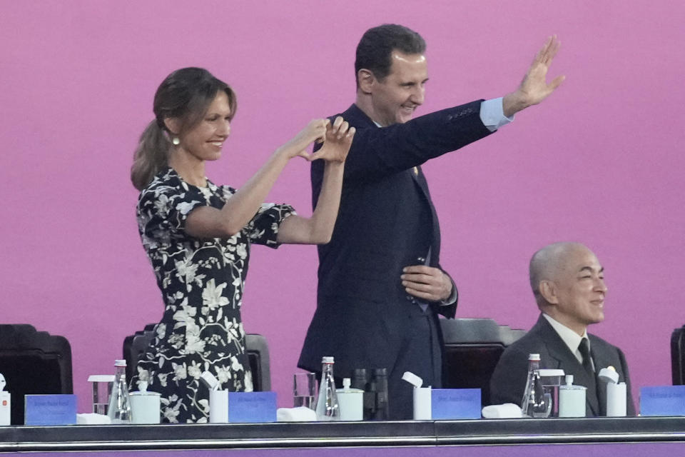 Syria President Bashar al-Assad, center, waves during the opening ceremony of the 19th Asian Games in Hangzhou, China, Saturday, Sept. 23, 2023. (AP Photo/Eugene Hoshiko)