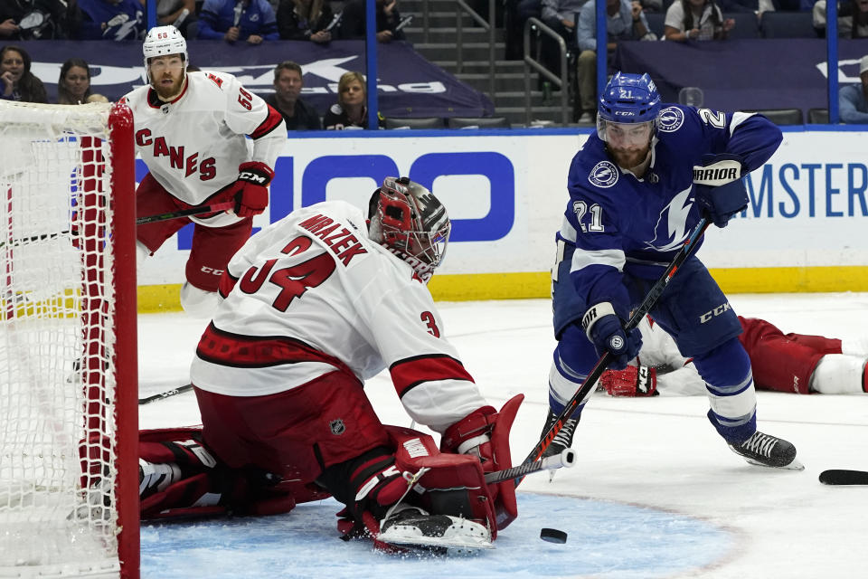 Carolina Hurricanes goaltender Petr Mrazek (34) stops a shot by Tampa Bay Lightning center Brayden Point during overtime in Game 3 of an NHL hockey Stanley Cup second-round playoff series Thursday, June 3, 2021, in Tampa, Fla. (AP Photo/Chris O'Meara)