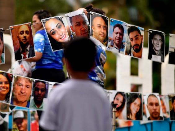 Portraits of the victims of the 25 January 2019 dam collapse on display during a tribute in Brumadinho (AFP via Getty Images)