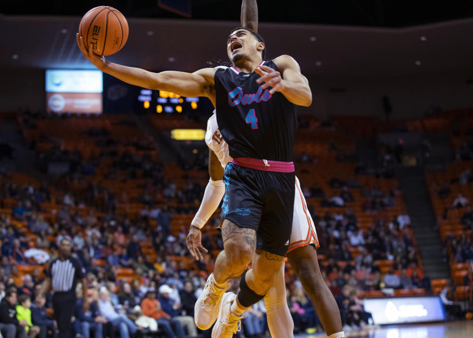 Florida Atlantic guard Bryan Greenlee (4) shoots in front of UTEP guard Mario McKinney Jr. (4) during the first half of an NCAA college basketball game Saturday, Jan. 21, 2023, in El Paso, Texas. (AP Photo/Andrés Leighton)