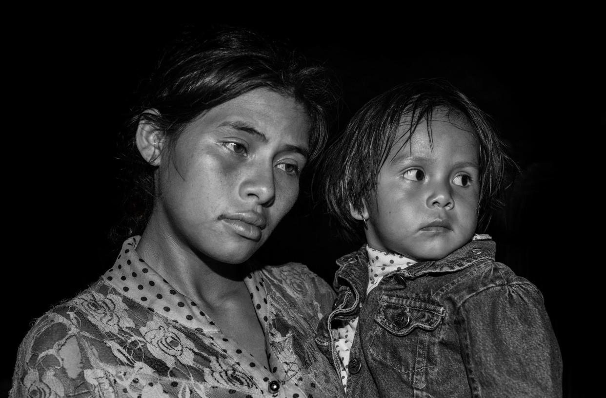 <i>Laura and Her Daughter</i><br />In late October 2018, after a nearly 500-mile trek, Laura and her daughter Erika crossed into Mexico from Honduras via the Suchiate River. Laura, age 19, had been carrying her daughter the entire journey and sometimes resorted to drinking water with sugar to fill their empty stomachs. (Photo: Ada Trillo)
