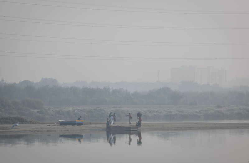 FILE PHOTO: A couple poses during a pre-wedding photo on the banks of Yamuna river on a smoggy morning in the old quarters of Delhi