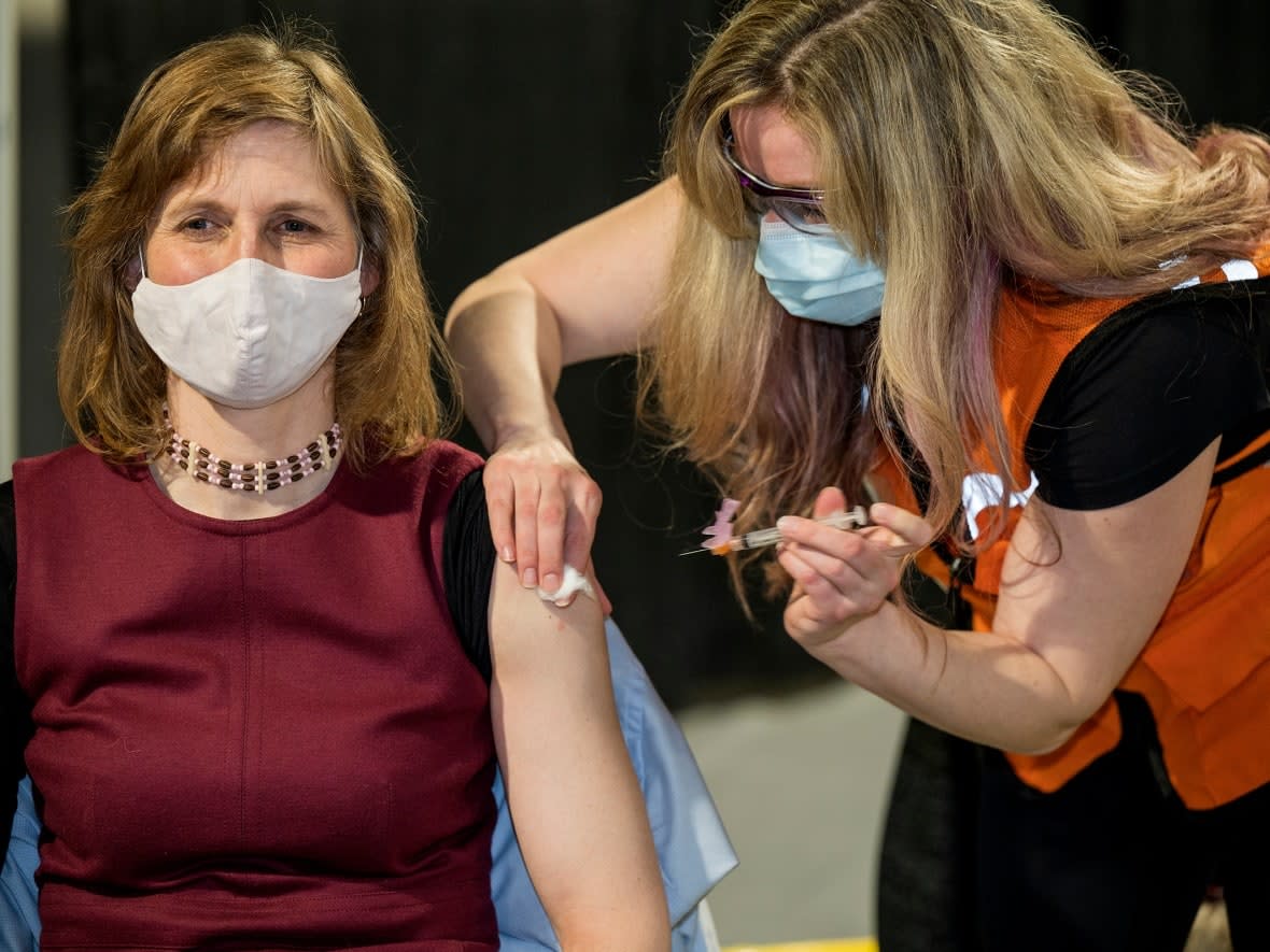 Yukon's Deputy Chief Medical Officer of Health, Dr. Catherine Elliot receives her COVID-19 vaccine on March 3. Yukon government employees have to have at least one dose of COVID-19 vaccine by Nov. 30. (Mike Thomas/The Canadian Press - image credit)