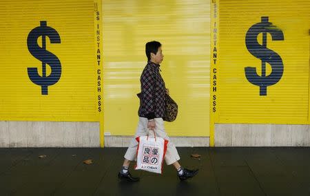 A woman walks past a pawn office in central Sydney May 7, 2009. REUTERS/Daniel Munoz