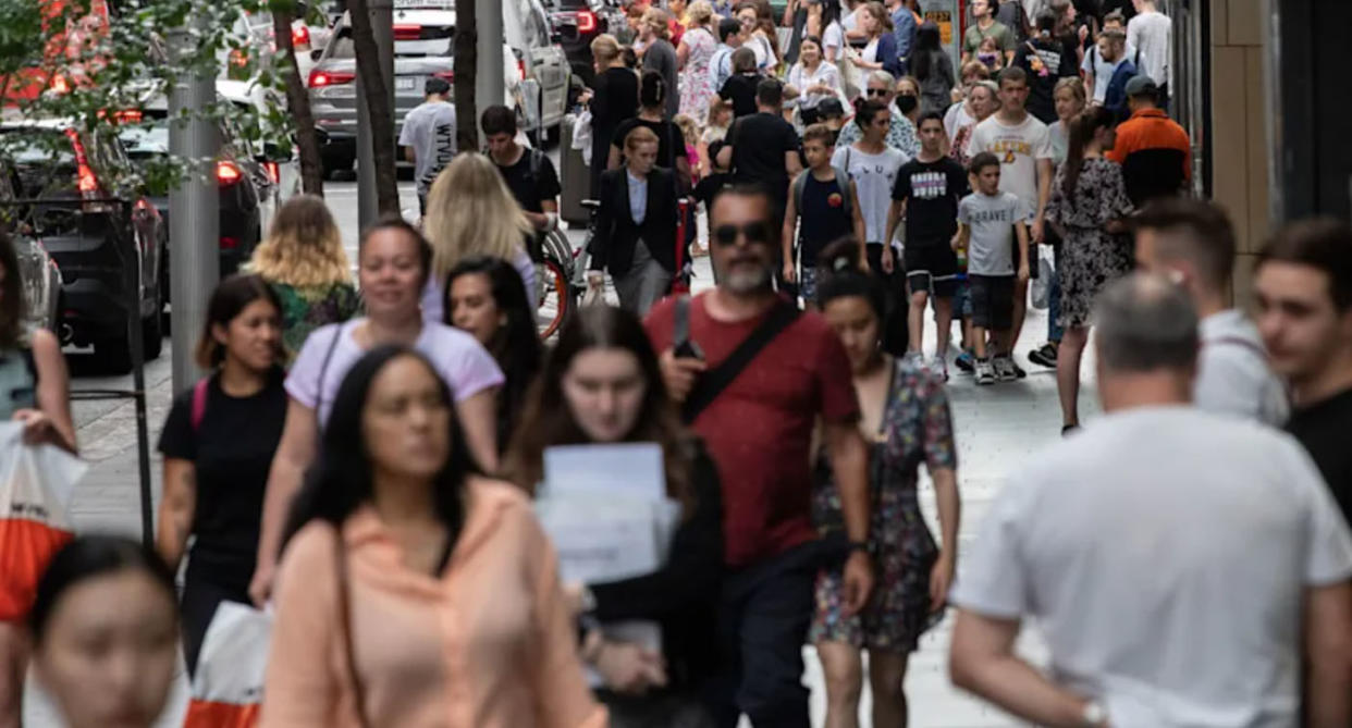 Sydney city street crowded with people as Omicron sweeps across NSW.