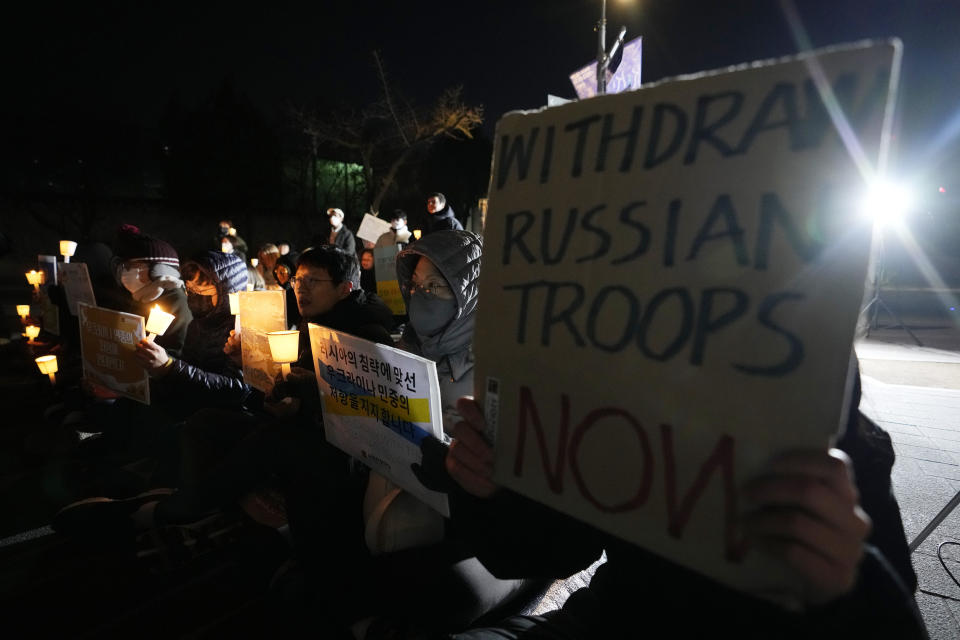 Protesters attend a vigil to mark the one-year anniversary of Russia's invasion of Ukraine, near the Russian Embassy in Seoul, South Korea, Friday, Feb. 24, 2023. (AP Photo/Ahn Young-joon)