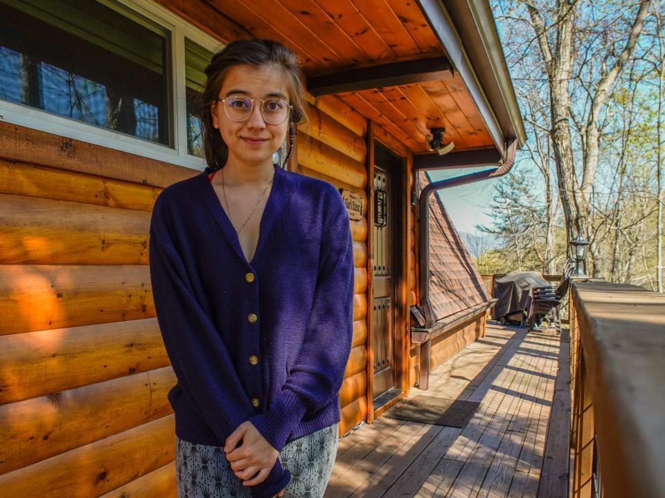 The author stands by the cabin's entrance.