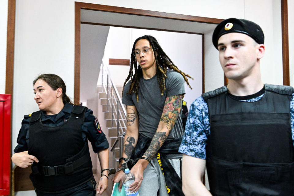 Brittney Griner is escorted by police officers in Russia while in handcuffs (Kirill Kudryavtsev / AFP via Getty Images file)