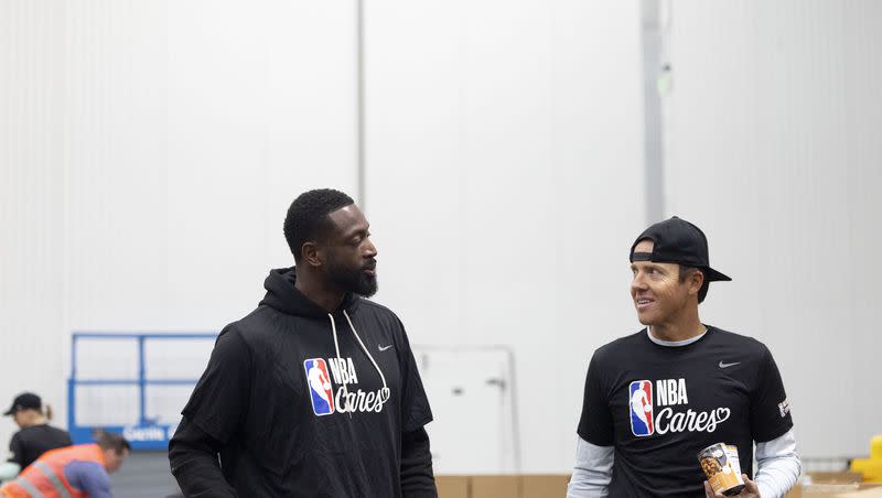 Utah Jazz minority owner Dwyane Wade and Utah Jazz owner Ryan Smith pack food donations to distribute to low-income students and families at the Bishops’ Central Storehouse in Salt Lake City on Friday, Feb. 17, 2023, as part of the NBA Cares day of service.