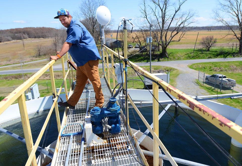 Black Bayou water treatment plant operator Jon Baldwin, on the catwalk atop the treatment facility above 15 feet of water in a holding tank, Friday, Mar. 25, 2022.