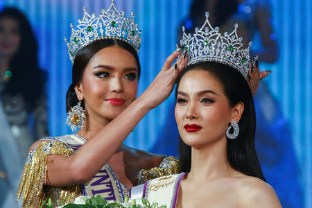 Contestant Jiratchaya Sirimongkolnawin of Thailand (R) reacts as she is crowned winner of the Miss International Queen 2016 transgender/transsexual beauty pageant in Pattaya, Thailand, March 10, 2017. REUTERS/Athit Perawongmetha