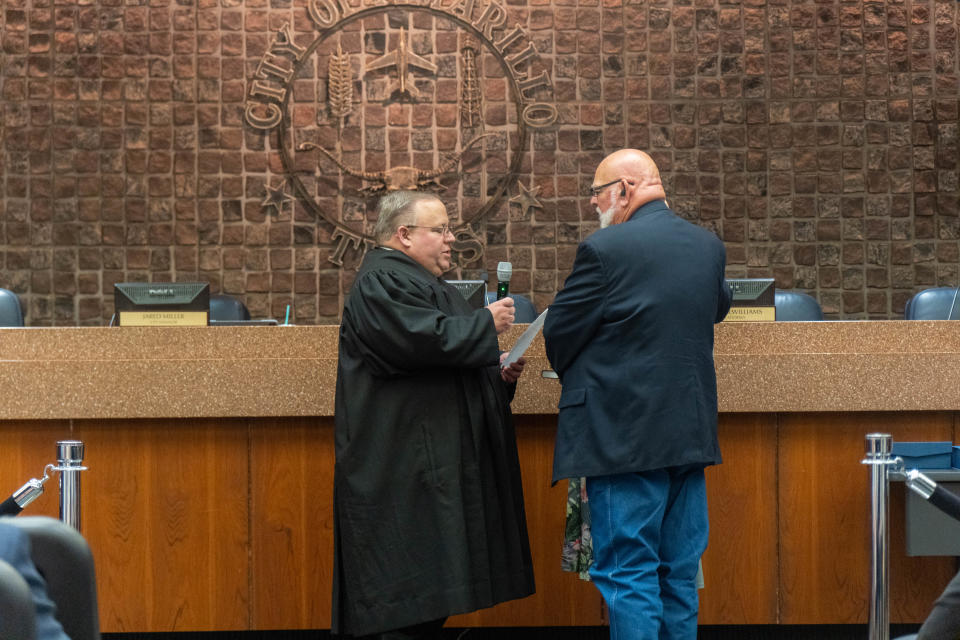 Newly elected councilmember Tom Scherlen is sworn in with his wife by district Judge Steven Denny at city hall in this file photo.