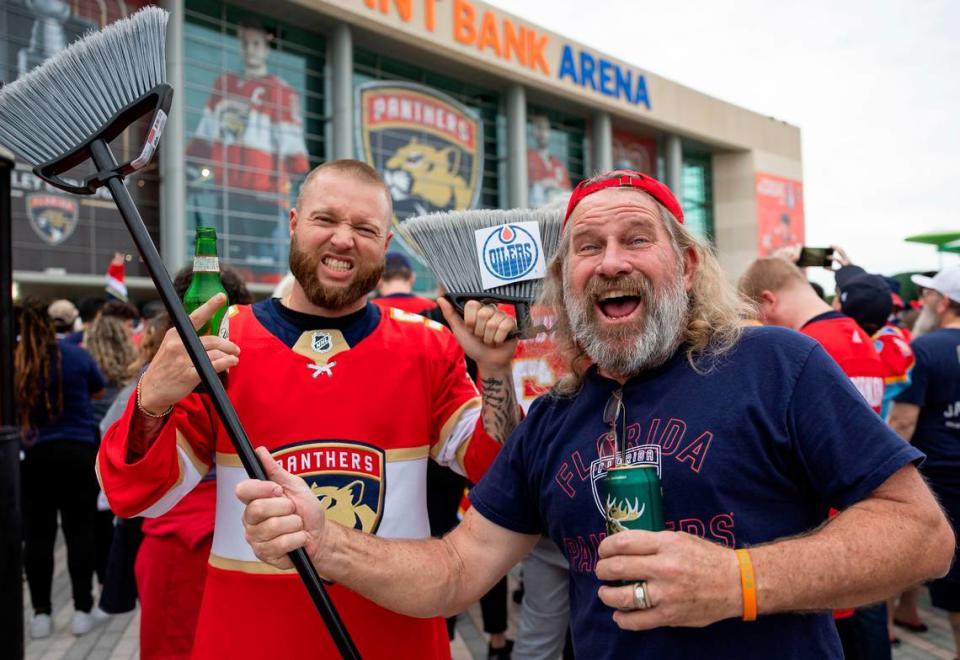 Florida Panthers fans Scott Castor, 57, right, and Derick Klingbiel , 34, arrive with their brooms ready for a sweep.