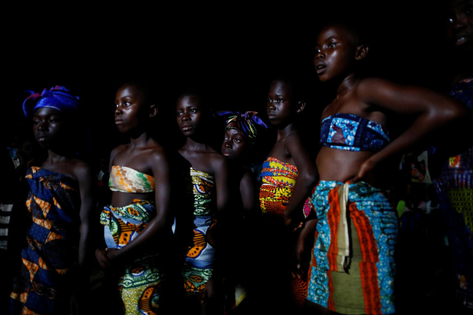 Children dressed in traditional-style cloth wrappings entertain residents of Kofi Gyan, a village on Tarkwa-Bogoso road, with a nighttime cultural performance. (Photo: Francis Kokoroko/Reuters)