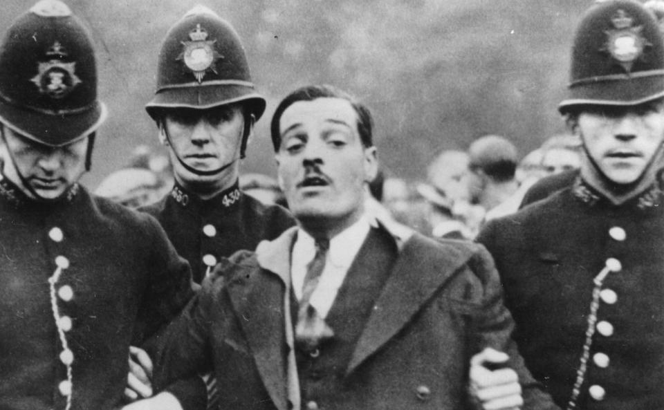 An anti-fascist is taken away by the police during the battle for Cable Street