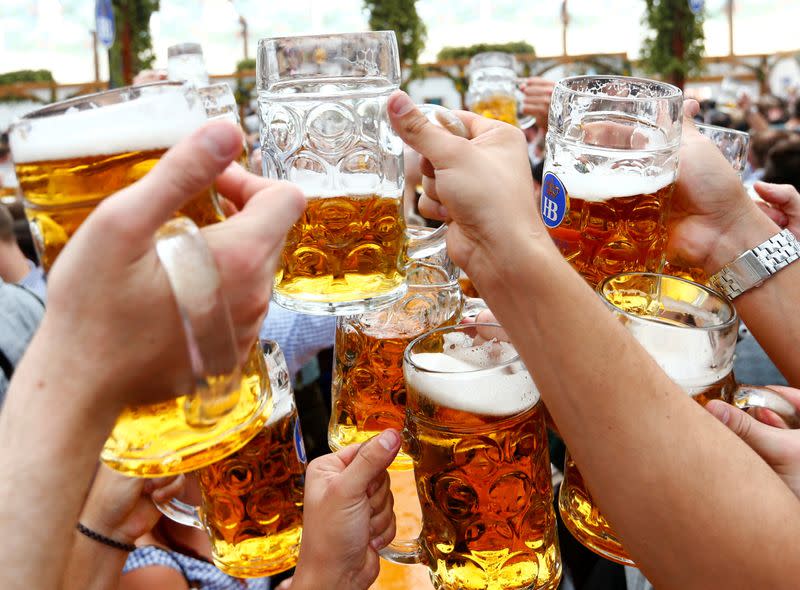 FILE PHOTO: Visitors toast with beer