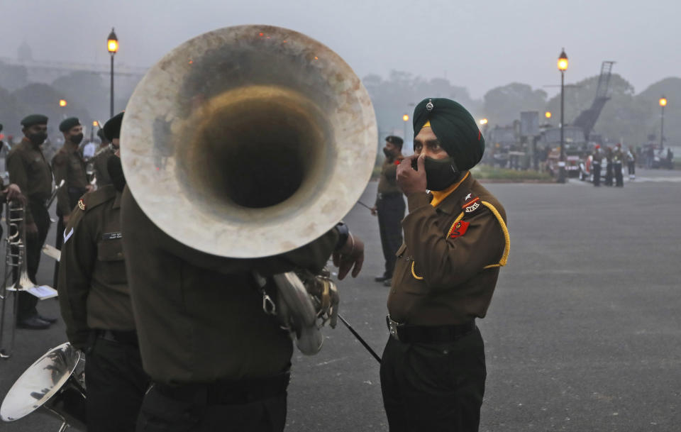 Army band soldiers talk as they prepare to march during rehearsals for the upcoming Republic Day parade at the Raisina hills, the government seat of power, in New Delhi, India, Monday, Jan. 18, 2021. Republic Day marks the anniversary of the adoption of the country's constitution on Jan. 26, 1950. Thousands congregate on Rajpath, a ceremonial boulevard in New Delhi, to watch a flamboyant display of the country’s military power and cultural diversity. (AP Photo/Manish Swarup)