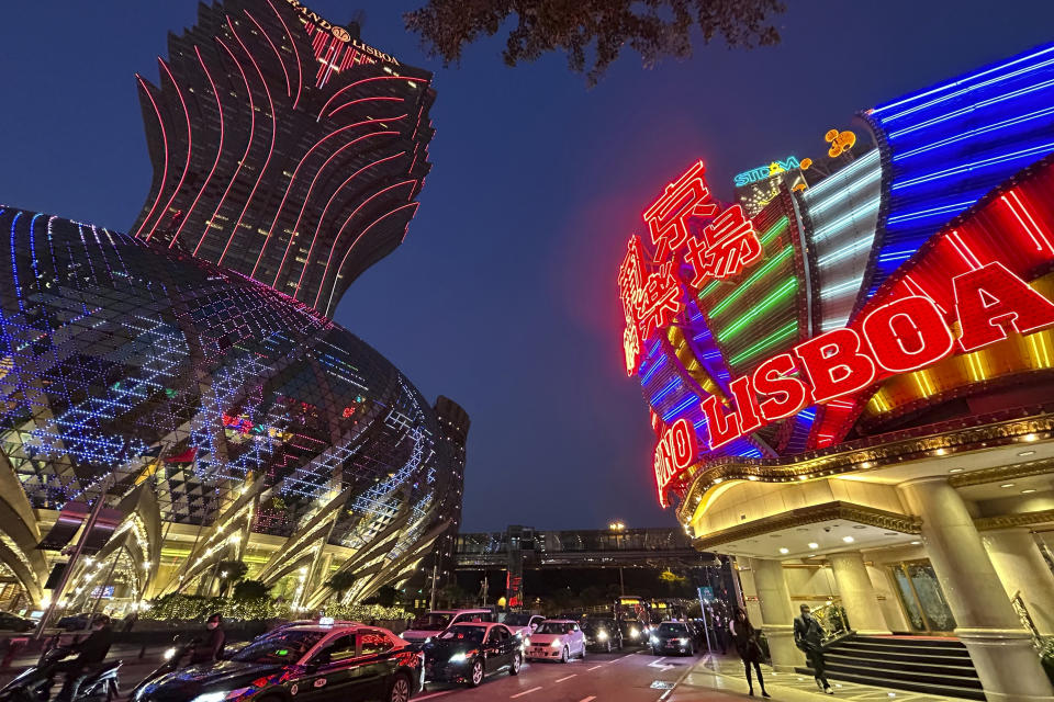 Casino Lisboa, right, is seen in Macao on Dec. 28, 2022. Gambling haven Macao’s relaxation of border restrictions after China rolled back its "zero-COVID" strategy is widely expected to boost its tourism-driven economy. The gaming hub on China's south coast near Hong Kong has endured some of the world’s strictest anti-virus controls for nearly three years. Now, China's worst wave of infections so far is keeping away the hoards of high rollers who usually fill its casinos. (AP Photo/Kanis Leung)