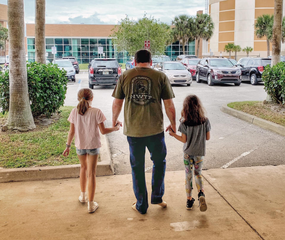 This photo provided by Roush Racing shows NASCAR driver Ryan Newman and his daughters, Brooklyn Sage, left, and Ashlyn Olivia, leaving Halifax Medical Center, Wednesday, Feb. 19, 2020 in Daytona Beach, Fla. Ryan Newman was released from a Florida hospital on Wednesday, about 42 hours after his frightening crash on the final lap of the Daytona 500.(Roush Racing via AP)