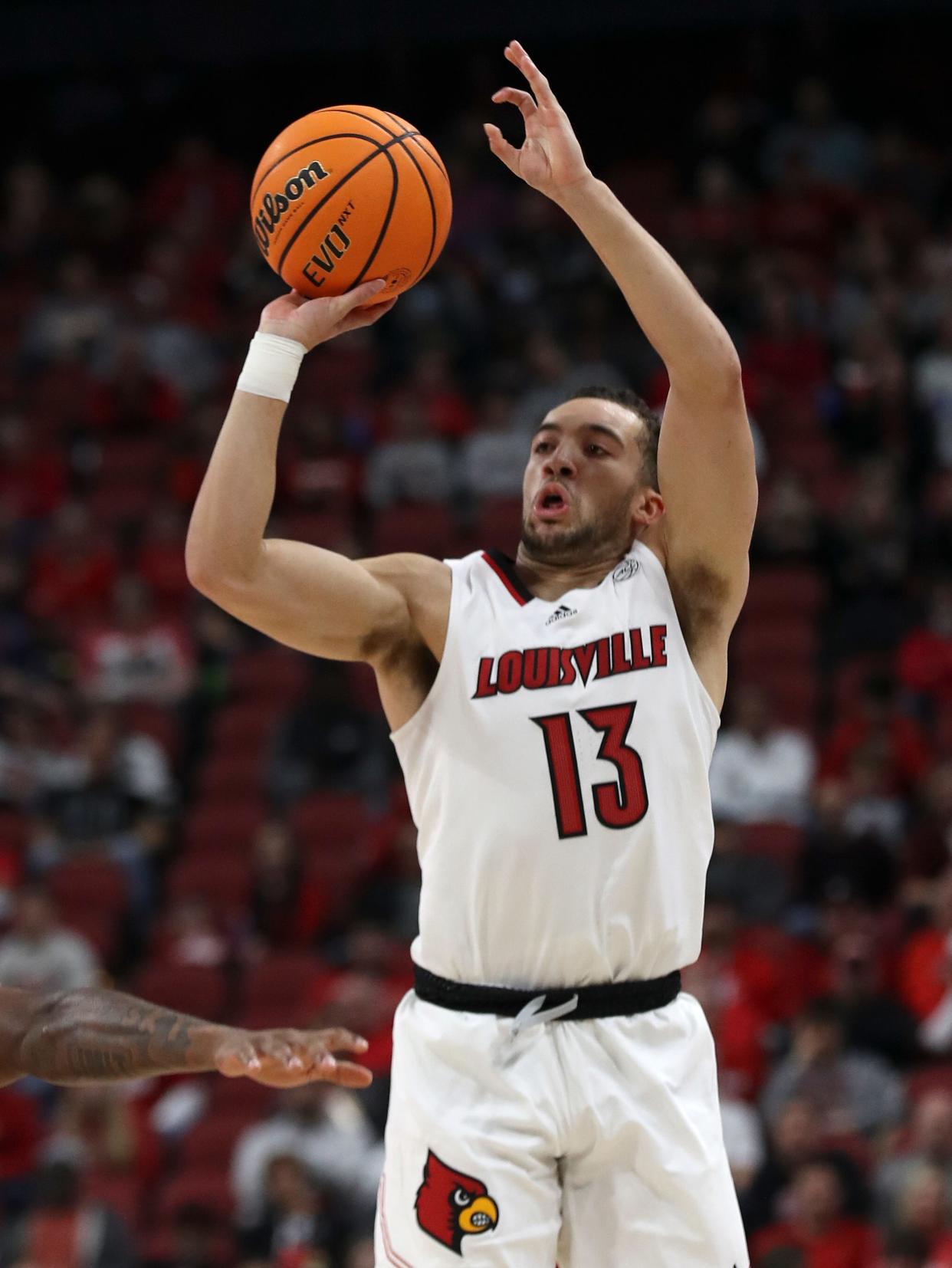 Louisville's Jarrod West shoots in the first half against Detroit Mercy