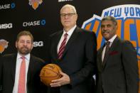New York Knicks new team president Phil Jackson, center, poses for photos with team owner James Dolan, left, and general manager Steve Mills, during a news conference where he was introduced, at New York's Madison Square Garden, Tuesday, March 18, 2014. (AP Photo/Richard Drew)