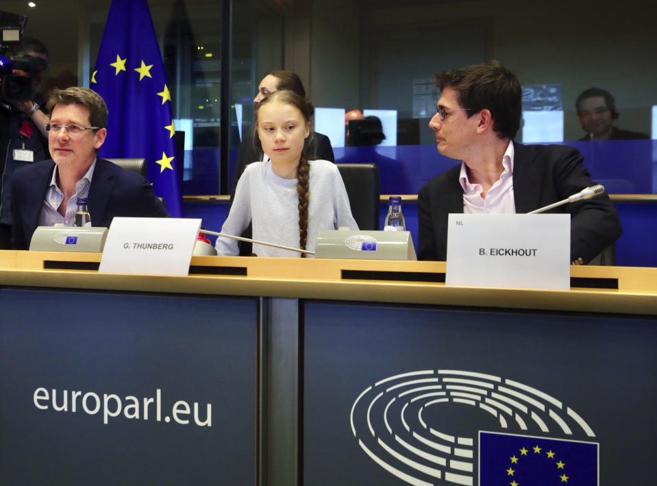 Swedish climate activist Greta Thunberg, center, addresses a meeting of the Environment Council at the European Parliament in Brussels, Wednesday, March 4, 2020. Climate activists and Green members of the European Parliament are urging the European Union to be more ambitious as the bloc gets ready to unveil plans for a climate law to cut greenhouse gas emissions to zero by mid-century. (AP Photo/Olivier Matthys)