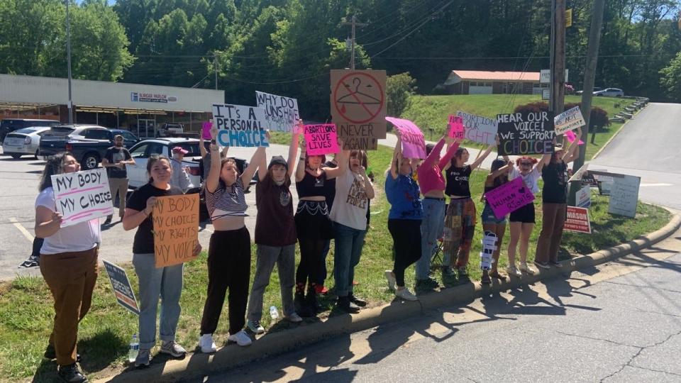 Students gathered outside Burger Parlor May 11 to hold a women's rights rally.