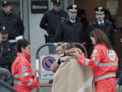 Relatives and friends comfort each others outside the morgue in Corinaldo, central Italy, Saturday, Dec. 8, 2018. A stampede at a rap concert in an overcrowded disco in central Italy killed five young teenagers and a woman who had accompanied her daughter to the event early Saturday, police said, adding that 59 people were injured. (AP Photo/Bobo Antic)