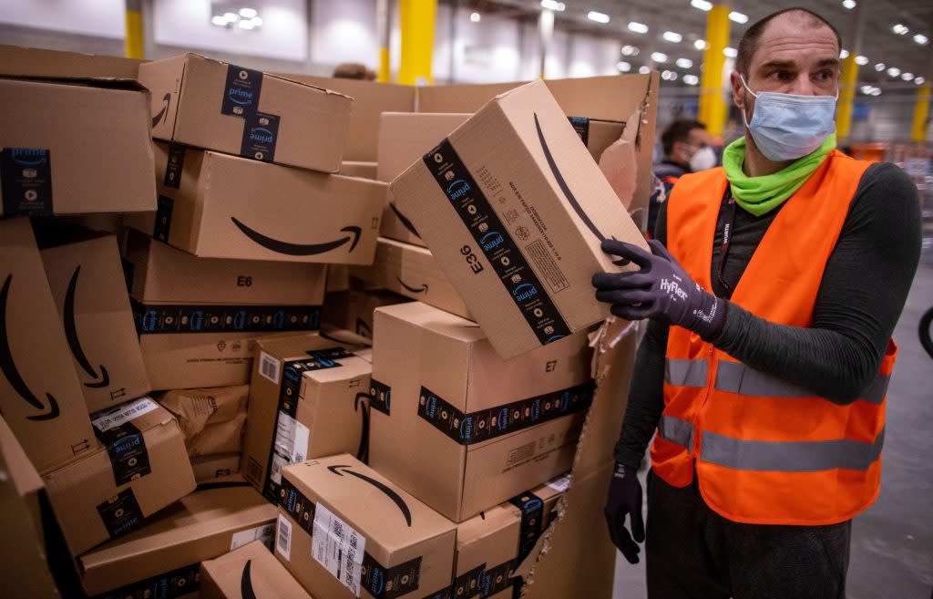 13 October 2021, Mecklenburg-Western Pomerania, Neubrandenburg: An employee sorts parcels on a conveyor belt in the new distribution center of the online retailer Amazon. The retailer's second distribution centre in Mecklenburg-Vorpommern will officially open on 13.10.2021. According to the operator, around 10,000 parcels from European logistics and sorting centres will be unloaded here every day and assigned to delivery vehicles. Photo: Jens Büttner/dpa-Zentralbild/dpa (Photo by Jens Büttner/picture alliance via Getty Images)