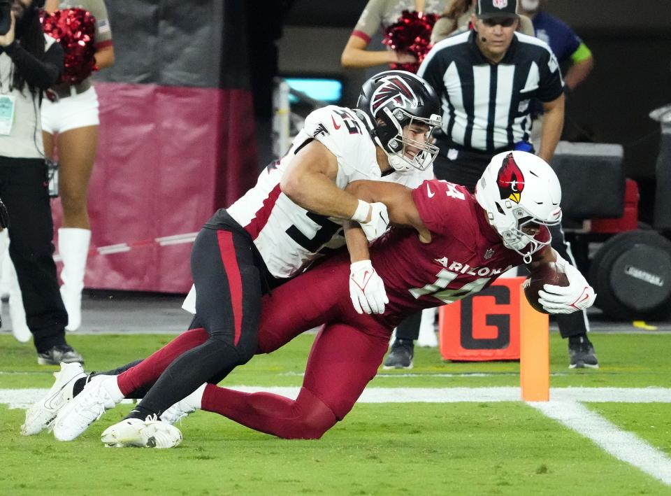 Arizona Cardinals wide receiver Michael Wilson (14) is down short of the goal line against Atlanta Falcons linebacker Kaden Elliss (55) in the second half at State Farm Stadium on Nov. 12, 2023, in Glendale.