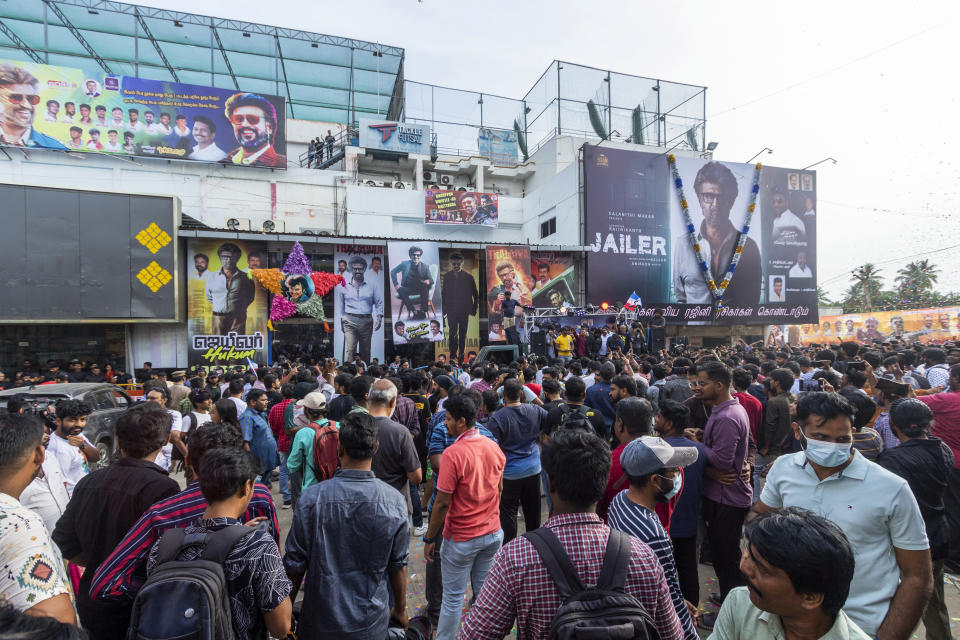 Fans of Indian superstar Rajinikanth, throng the premises of a cinema hall as they await the screening of his latest film "Jailer" in Chennai, India, Thursday, Aug. 10, 2023. (AP Photo/ R. Parthibhan)