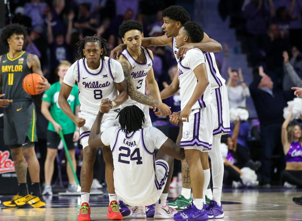 Kansas State forward Arthur Kaluma (24) is helped off the floor by his teammates after hitting a game-winning 3-pointer Tuesday against Baylor at Bramlage Coliseum.