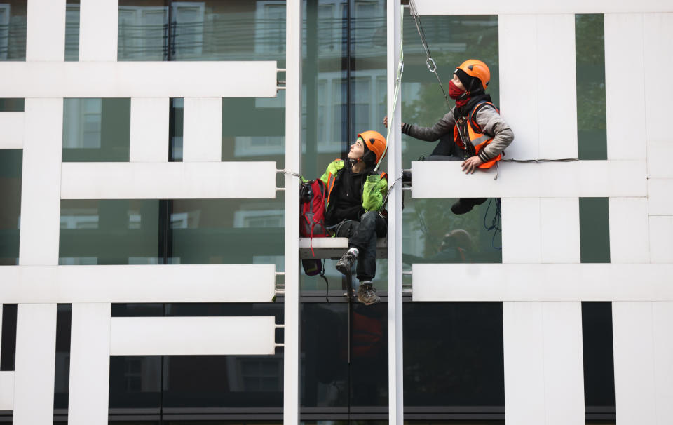 Activists from Animal Rebellion after scaling the outside of the Department for Environment, Food and Rural Affairs (Defra) in Westminster, central London, calling for the Government to invest in a plant-based future at the upcoming Cop26 conference in Glasgow. Picture date: Tuesday October 26, 2021.